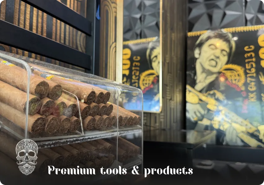 Display of premium cigars and exclusive artistic decor highlighting the use of top-tier products and tools in the barbershop.