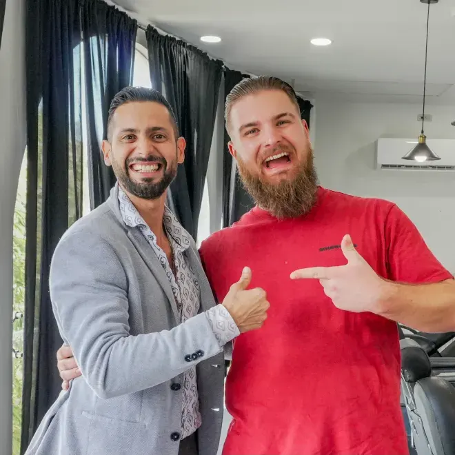 Client smiling with barber at Ace of Fades barbershop in Cancun’s Hotel Zone, showcasing a fresh haircut and friendly service.